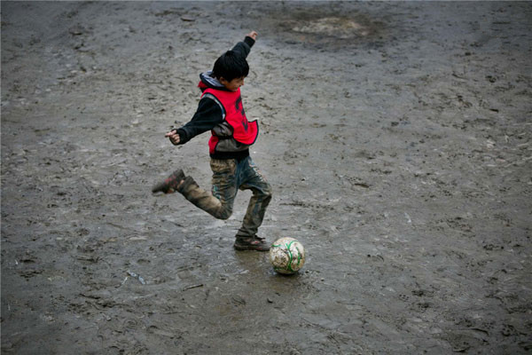 Dorjie Tsering plays football at the school. One about one year, the 11-year-old fifth grader will attend middle school at the county far away. Dorjie said his biggest wish was being able to play football with his friends forever.