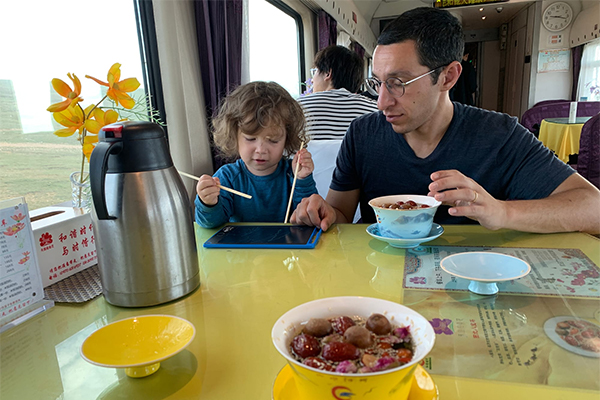A parent and a child in the dining car A parent and a child in the dining car