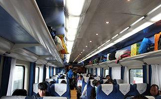 Hard seat carriage with luggage stored on the top