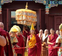 The 11th Panchen Lama is escorted by monks playing religious musical instruments and walks on a yellow carpet symbolizing noble auspiciousness to the Panchen Pagoda in the Xihuang Temple where the clothes of the 6th Panchen Lama was buried. The 11th Panchen Lama Bainqen Erdini Qoigyijabu gives blessings to monks and laymen by conducting a head-touching ritual in the Xihuang Temple of Beijing on May 18.